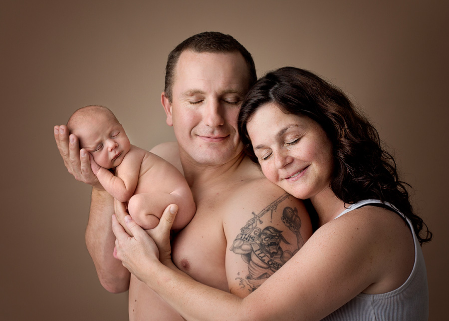 mom, dad and newborn pose