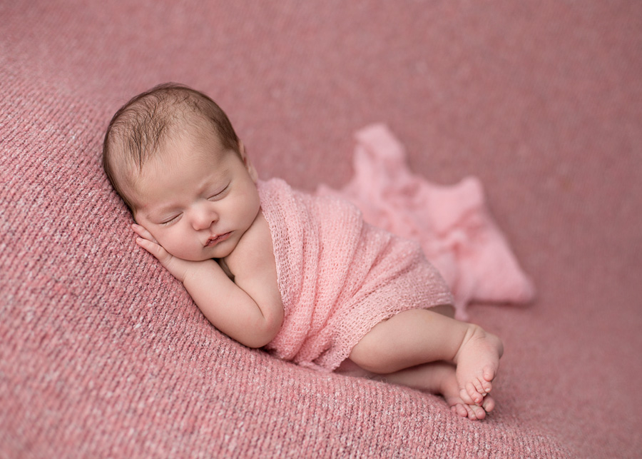 snuggle baby pose with pink wrap