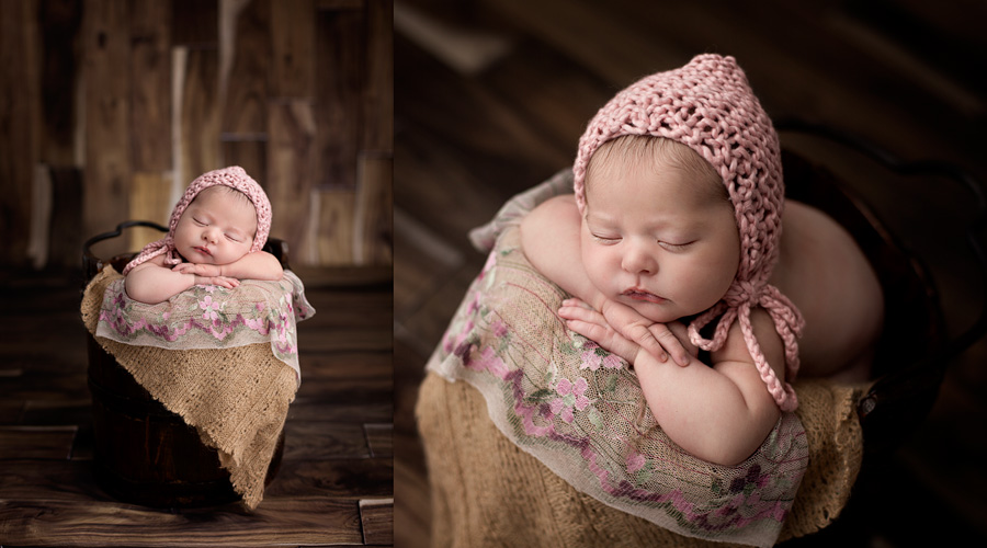 newborn baby girl in bucket with pink bonnet