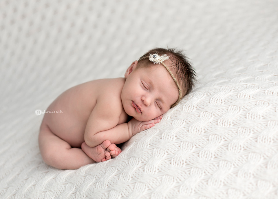 baby girl in taco pose on white fabric