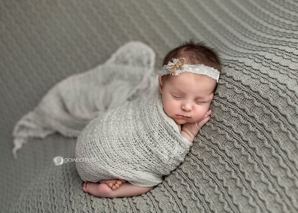 newborn in green wrapped