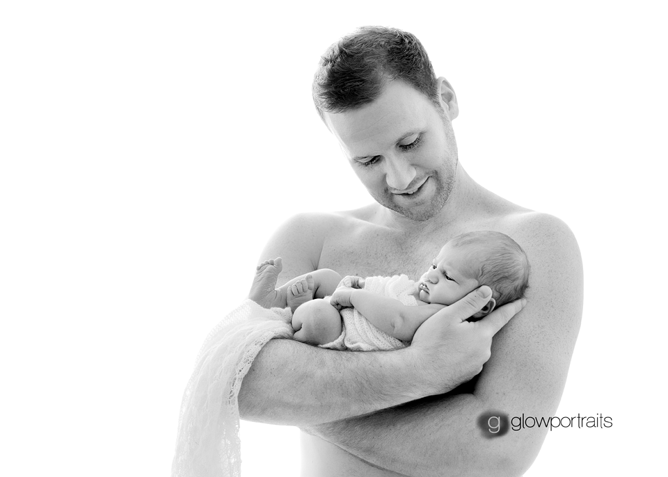 dad holding his newborn daugther