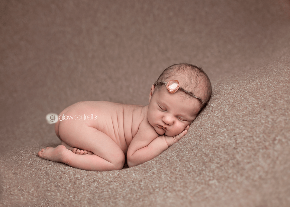 newborn on beanbag in tushie up pose