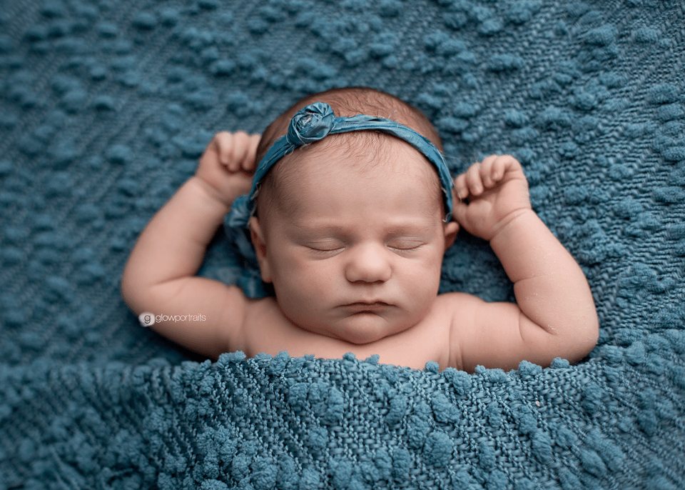 newborn on blue blanket pose