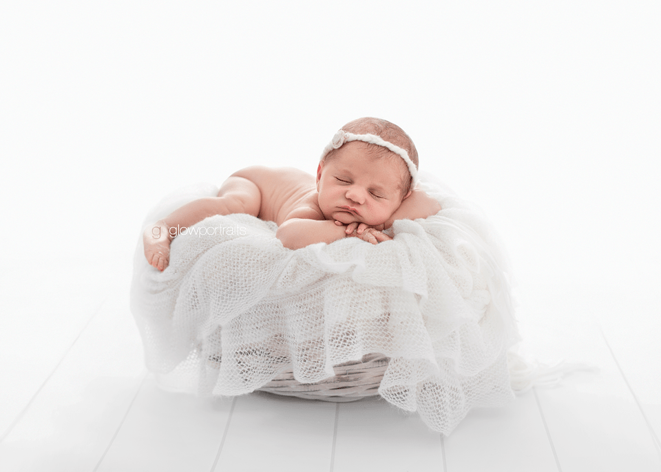 backlit newborn on white material