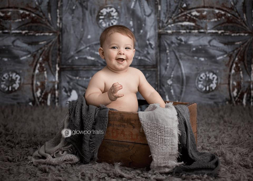 smiling baby in wood box