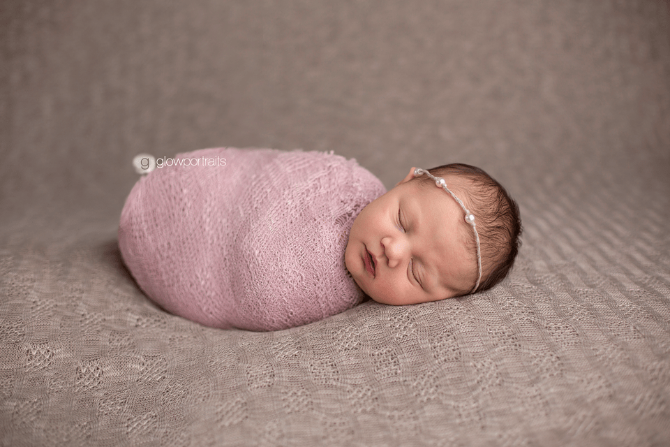 newborn girl tightly wrapped up