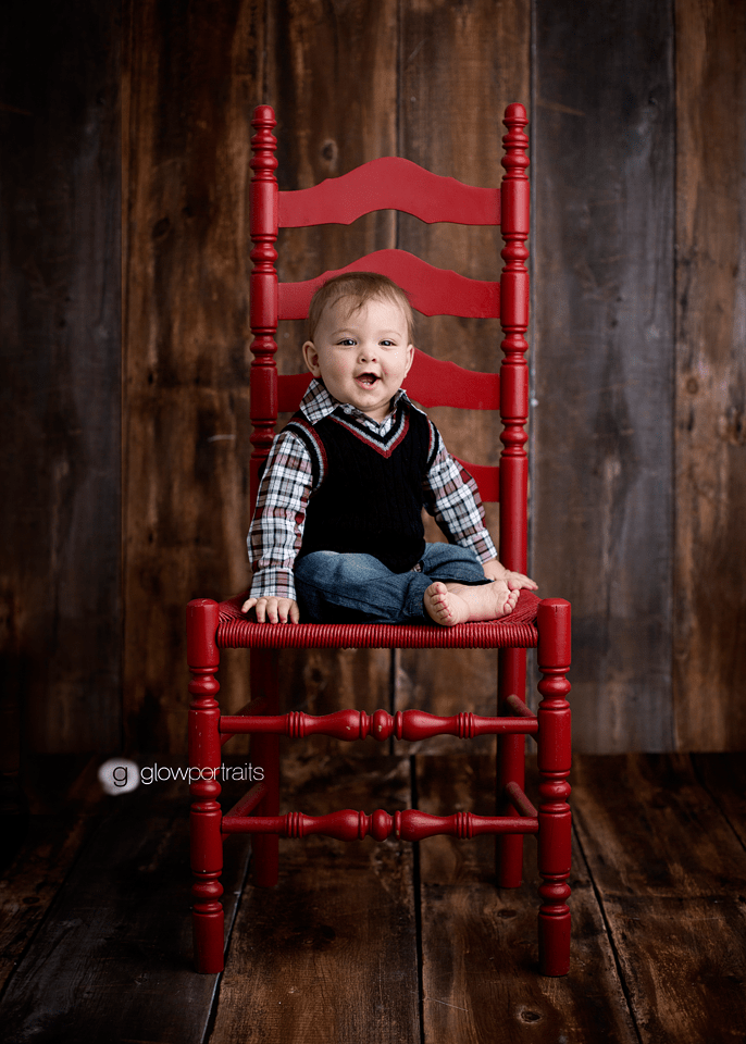 little baby boy sitting in red chair